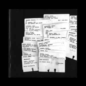 a pile of white rolodex cards on black background